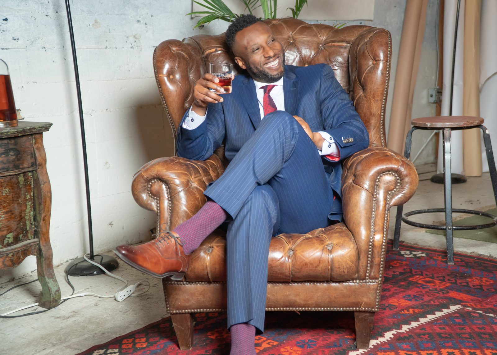 Ronnell Richards seated with bourbon, editorial portrait